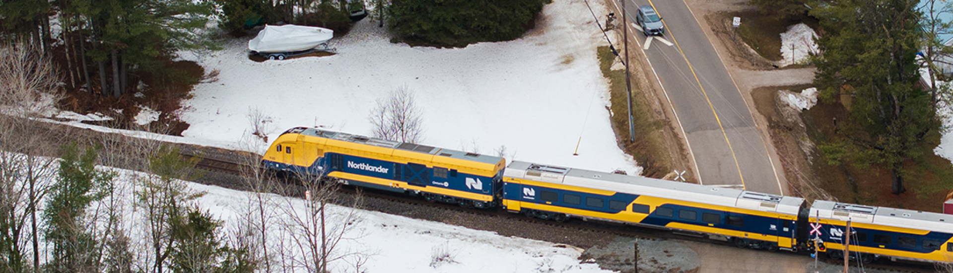 Drone image of Nortlander train passing a rail crossing